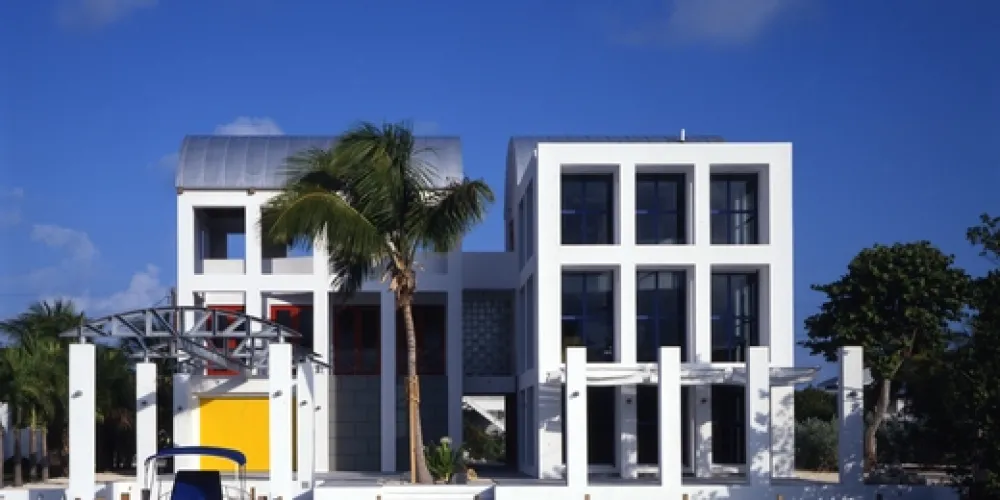 An architectural marvel with a curved roof adds modern elegance to the waterside residence, amplifying its striking appeal and providing an ideal setting for both privacy and interaction.

