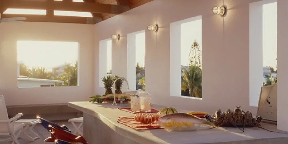 Bask in the open-air charm of a high terrace with lively, colorful seats and a bar. This space is inviting for social gatherings, blending modern style with an island vibe for entertaining.

