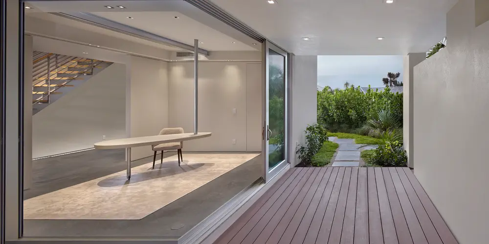 Sophisticated modern architecture with this custom home design, where minimalist aesthetics meet luxurious functionality. Expansive glass walls blur indoor and outdoor boundaries, allowing natural light to illuminate the serene interior. Rich textures and sleek lines create a harmonious living experience, ideal for those seeking elegance and simplicity in design.