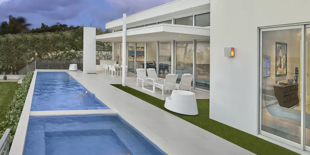 This poolside terrace highlights a seamless transition from indoor to outdoor living, featuring a stunning combination of a long, sleek pool and an inviting Jacuzzi. The sophisticated terrace design offers stylish outdoor furniture and ample space for relaxation, encapsulating the luxurious essence of coastal living.
