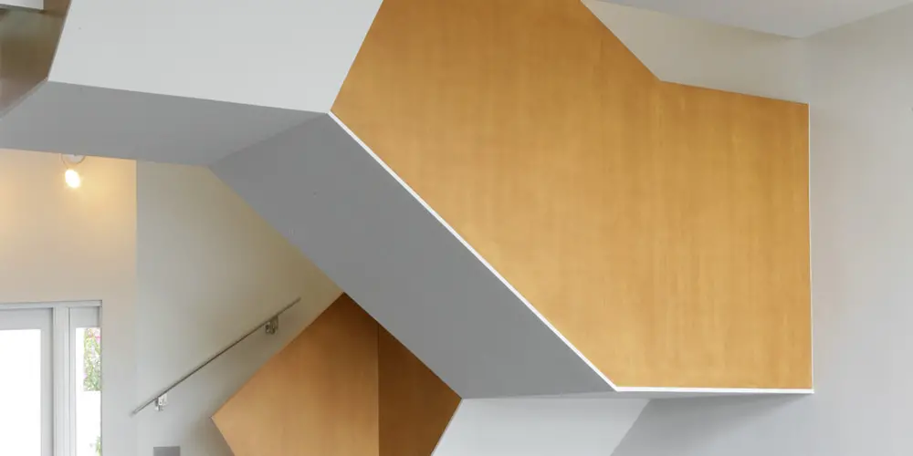  This image captures the staircase as an architectural sculpture within the home. Its bold geometric shape contrasts with sleek floors, amplifying its modern design statement.