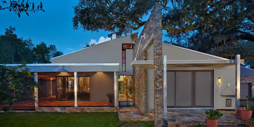 The architectural style reflects a sleek, contemporary design with clean lines and geometric shapes. Large glass panels and sliding doors enhance the building’s minimalist facade, allowing for ample natural light and an ongoing dialogue between the interior and exterior spaces.

